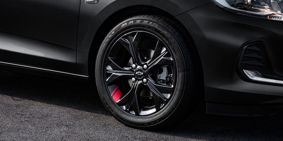 Chevrolet Onix 2025 versión Redline, sedán deportivo con detalles en rojo en sus rines de 16 pulgadas